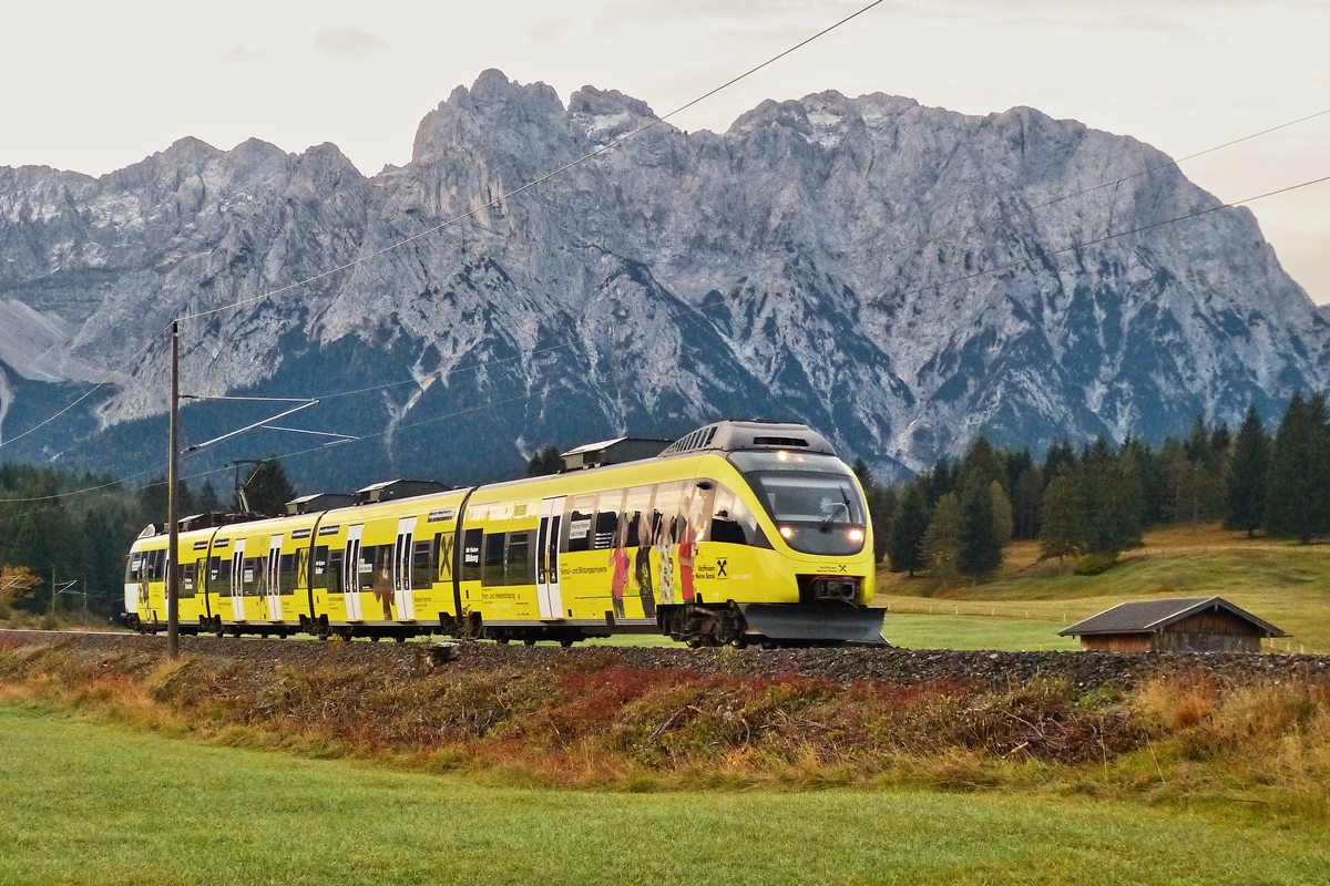 . Der fr�he Vogel f�ngt den Wurm - W�hrend im Landhaus Wackerl am 05.10.2015 noch alle schlafen, konnte ich die �BB Ente mit ihrer Werbung vor dem Karwendel in Mittenwald ablichten. Der �BB Talent 4024 088-9 f�hrt als RB 5404 von Innsbruck nach Garmisch Partenkirchen . (Hans)