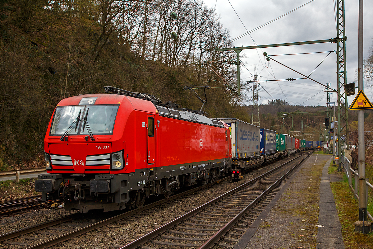 Die DB 193 337 (91 80 6193 337-3 D-DB) fährt am 06.04.2022 mit einem KLV-Zug durch Scheuerfeld (Sieg) in Richtung Siegen. Nochmals einen lieben Gruß an den netten Lokführer zurück, der mich hier mit Handzeichen und Lichtsignal freundlich grüßte. 

Die Siemens Vectron MS (200 km/h - 6.4 MW) wurden 2018 von Siemens unter der Fabriknummer 22417 und gebaut, sie hat die Zulassungen für  D / A / CH / I / NL / B  (Deutschland, Österreich, Schweiz, Italien, Niederland und Belgien) und kann so vom Mittelmeer bis an die Nordsee ohne Lokwechsel durchfahren.

So kann diese Lok diesen KLV-Zug, durch die Schweiz, bis nach Italien bringen. Wobei die Lokführer wechseln, so fahren in der Schweiz Schweizer und in Italien italienische Lokführer.