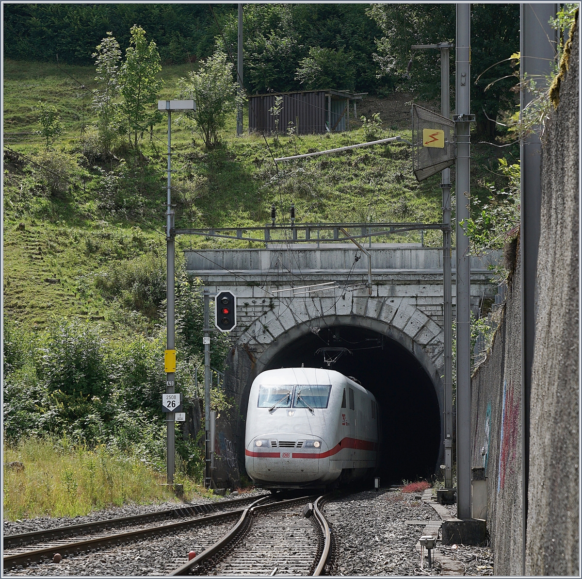Infolge Gleisbauarbeiten und des damit verbunden Einspurbetriebs zwischen Tecknau und Gelterkinden werden die IC 61 und IR 27 sowie die in diese Taktlagen eingebundenen internationalen Züge in der Fahrtrichtung Süd-Nord via Alte Hauensteinlinie umgeleitet. 

Das Bild zeigt den ICE 10278 auf seiner Fahrt von Interlaken Ost nach Berlin Ostbahnhof beim verlassen der 2495 Meter langen Hauensteintunnel in Läufelfingen.
11. Juli 2018 
