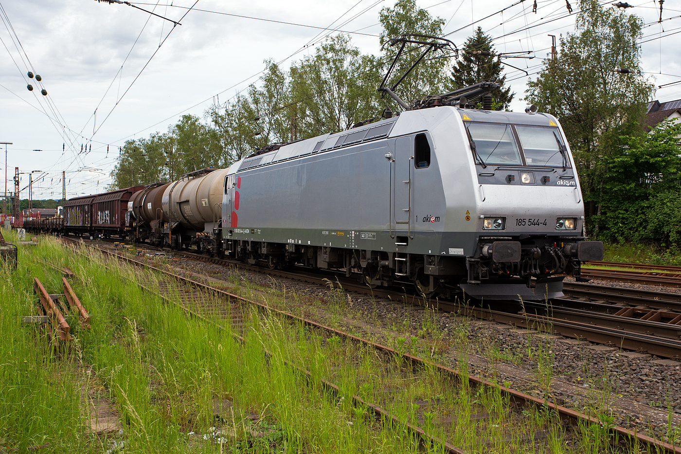 Die mit DACH-Zulassung (Deutschland, Österreich und Schweiz) an die DB Cargo AG vermietete Akiem 185 544-4 (91 80 6185 544-4 D-AKIEM), ex MRCE Dispolok (91 80 6185 544-4 D-DISPO), fährt am 21 Mai 2024 mit einem gemischten Güterzug von Kreuztal weiter in südlicher Richtung. Zuvor hatte sie beim Bahnhof Kreuztal länger Hp 0.

Nochmals einen lieben Gruß an den netten Lokführer zurück.

Die TRAXX F140 AC1 wurde 2005 von Bombardier Transportation GmbH in Kassel unter der Fabriknummer 33729 gebaut und an die MRCE - Mitsui Rail Capital Europe geliefert. An die AKIEM SAS wurde sie 2023 verkauft. Sie hat die Zulassungen für Deutschland, Österreich und die Schweiz (D/A/CH), die zugel. Höchstgeschwindigkeit beträgt 140 km/h. 
