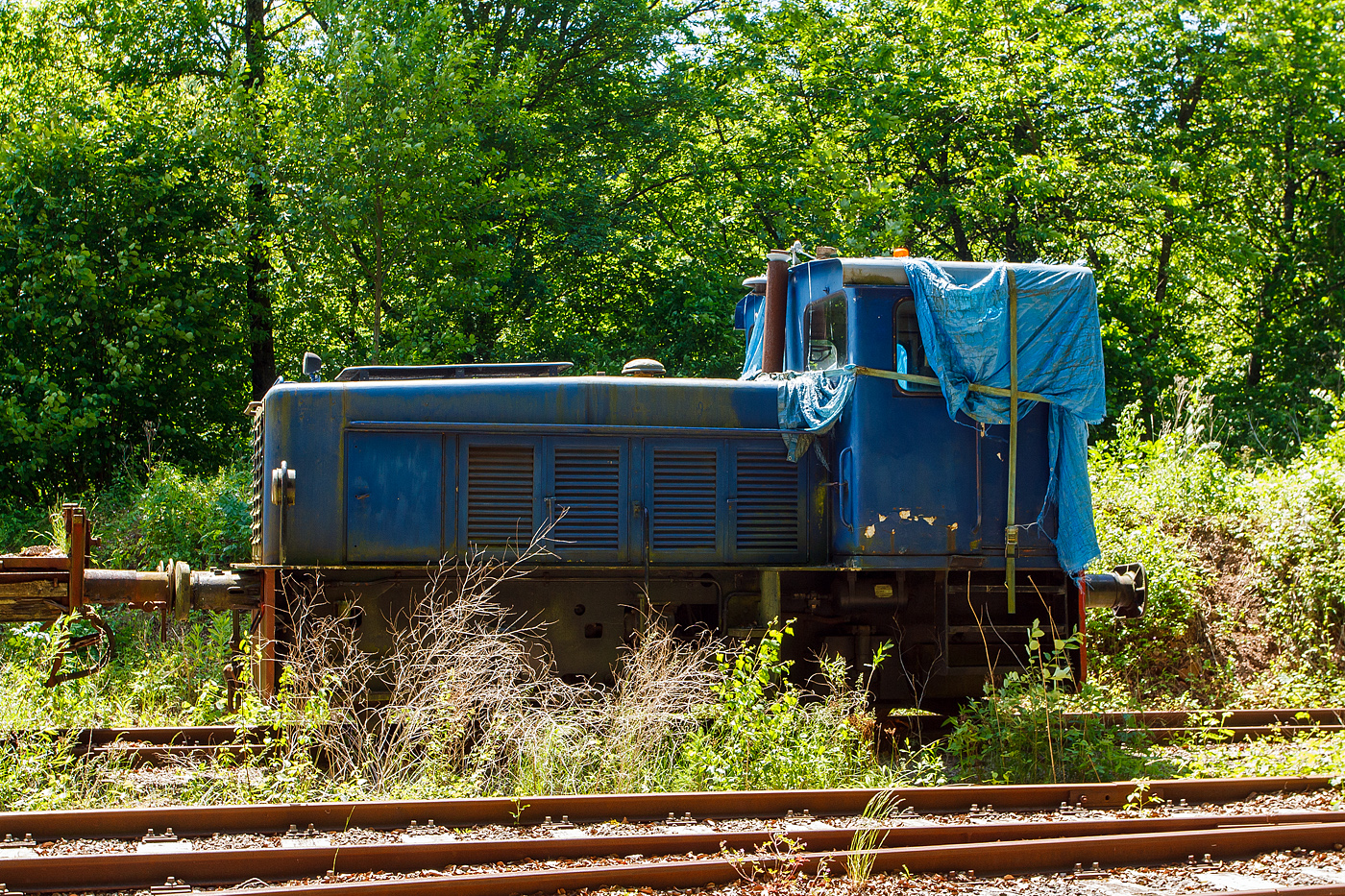 Leider schon in einem sehr schlechten Zustand pr�sentierte sich am 16 Juni 2013 die AMTF No 30, ex ARBED 130, ex ARBED 30, AES DH2, eine zweiachsige hydraulische Diesellokomotive vom Typ Jung RC 24 B (R = Regelspur, C = Antrieb �ber Gelenkwellen, 24 = 1/10 der Leistung in PS, B = 2 Achsen), bei der AMTF - Association des Mus�e et Tourisme Ferroviaires a.s.b.l. in Fond-de-Gras.

Die zweiachsige hydraulische Diesellokomotive wurde 1965 von der Arnold Jung Lokomotivfabrik GmbH in Jungenthal bei Kirchen an der Sieg unter der Fabriknummer 13870 gebaut und im Februar 1966 an die Eisenh�tte Arbed Esch-Schifflange AES als DH 2 geliefert. Hier lief sie oft mit ihrer Schwester, Kabine an Kabine, gekuppelt. Bei der Fusion der Lokbetriebe der ARBED (Aci�ries R�unies de Burbach-Eich-Dudelange SA, heute ArcelorMittal) erhielt sie erst die Bezeichnung ARBED 30, sp�ter ARBED 130. Einzeln lief sie dann auch in Belval bis sie �berz�hlig wurden. Nach langen Verhandlungen konnte die AMTF Ende der 1990er Jahre einen ihrer Finanzen entsprechenden Kaufpreis erreichen, und die Lok ging an die AMTF - Association des Mus�e et Tourisme Ferroviaires a.s.b.l. in Fond-de-Gras, wo sie die Nr. 30 bekam. Man musste aber einen Motordefekt feststellen. Zus�tzliche Kosten waren f�r die Austauschteile bei MTU (Mercedes) zu erwarten, doch Mechaniker vom TICE (Transport intercommunal de personnes dans le canton d'Esch-sur-Alzette) haben unentgeltlich gute Arbeit geleistet. Nachdem die meisten Beulen aus der Karosserie ausgebessert waren wurden sie blau gestrichen. Die Leistung der Lok gen�gte aber nicht um einen 3 Wagen Zug die Steigung von P�tange (Petingen) hochzuziehen.

Die Loks:
In den Nachkriegsprogrammen bot Jung ein zweiachsiges Muster f�r Industriebahnen mit unterschiedlichen Motorleistungen an. Die Fahrzeuge wiesen ein endst�ndiges F�hrerhaus und einen halbhohen, schmalen Motorvorbau auf. Die �u�ere Erscheinung des Musters blieb auch bei Umstellung von Ketten- auf Gelenkwellenantrieb weitgehend unver�ndert. Die gr��ten St�ckzahlen erreichten die Typen RK 15 B und RK 20 B (je 20 St�ck) sowie RC 24 B (26 St�ck).

Zur 4. Generation geh�rte die Jung RC 24 B (R = Regelspur, C = Antrieb �ber Gelenkwellen, 24 = 1/10 der Leistung in PS, B = 2 Achsen), eine zweiachsige hydraulische Diesellokomotive f�r den Rangier- und Verschubbetrieb, von denen 26 St�ck zwischen 1963-1976 von der Lokomotivfabrik Jung gebaut wurden. 

Technik:
Die Lokomotiven besitzen einen einfachen Vorbau f�r die Maschinenanlage und einen dahintergelegenen F�hrerstand. Der Maschinenraum war zur Verbesserung der Streckensicht im vorderen Teil abgewinkelt. Der Vorbau hatte T�ren zur Wartung der Maschinenanlage. Im F�hrerhaus befindet sich der F�hrertisch in der Mitte der Vorderwand. Bedienelemente f�r Fahren und Bremsen sind auf beiden F�hrerhausseiten vorhanden. Die Lok besitzt einen Blechrahmen aus Blechwangen mit einer St�rke von 15 mm sowie einer Pufferbohle. Der gesamte Rahmen ist in Schwei�bauweise hergestellt. Das Laufwerk besteht aus zwei mit Blattfedern abgefederten Achsen mit Gleitlagern. Die Federn st�tzen sich oberhalb der Achslager ab. Der Achsstand betr�gt 2.500 mm.

Die Maschinenanlage bestand aus einem wassergek�hlten aufgeladenen 6-Zylinder-Viertakt-Reihendieselmotor vom Typ Daimler-Benz MB 846 A mit einer Leistung von 184 kW (250 PS). �ber das nachgeschaltete Getriebe (Str�mungswendegetriebe) vom Typ Voith RS 18 Z erfolgt die Kraft�bertragung hydraulisch �ber zwei Gelenkwellen auf die beiden Achsgetriebe. 

TECHNISCHE DATEN:
Gebaute Anzahl: 26
Spurweite: 1.435 mm (Normalspur)
Achsordnung: B (2 Achsen)
L�nge �ber Puffer: 6.840 mm
H�he: 3.600 mm
Breite: 2.970 mm
Radstand: 2.500 mm
Dienstgewicht: 30t
Max. Achslast: 15,0 t
Dieselmotor Typ: 6 Zyl. Daimler-Benz MB 846A, 
Motorleistung: 184 kW (250 PS) bei 1.500 U/min
Getriebe: Voith RS 18 Z
Kraft�bertragung: dieselhydraulisch �ber Gelenkwellen auf die Achsen
H�chstgeschwindigkeit: 20 km/h
Kleinster befahrbarer Radius: 35 m
