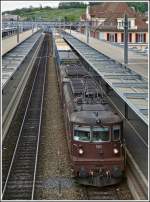 Zwei BLS Re 4/4 ziehen am 22.05.2012 eine  blaue Wand  durch den Bahnhof von Spiez.