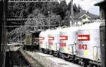 RhB Ge 6/6 I Nr.415 mit Zement-Silowagen in Reichenau-Tamis am 01.07.1993.