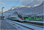 Im noch im Schatten liegenden Bahnhof von Aigle warten TPC -Züge auf ihre Abfahrt nach Champéry und Les Diablerets während ein SBB RABe 503 (ETR 610) als EC 37, von Genève nach